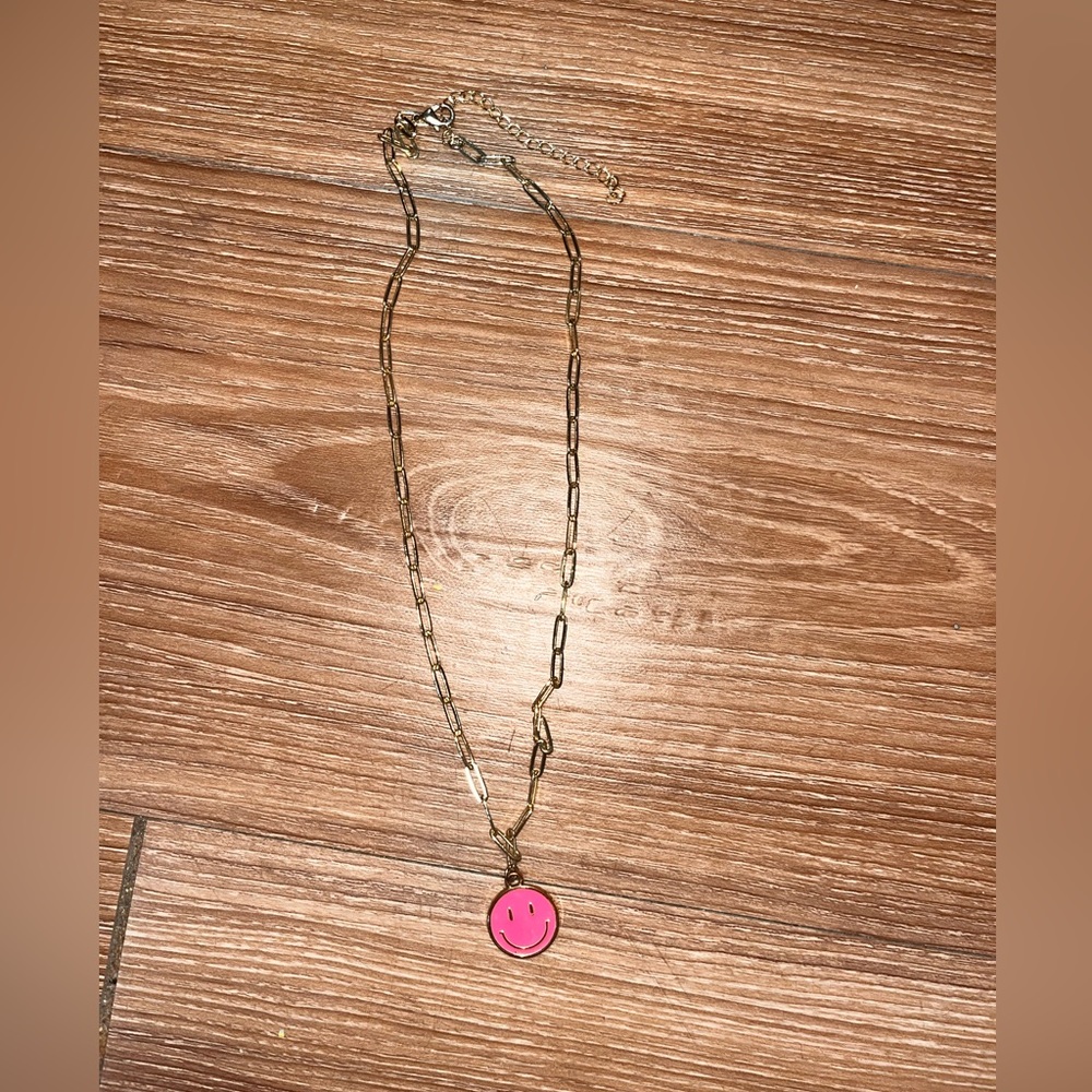 Gold chain necklace with neon pink smiley face pendant